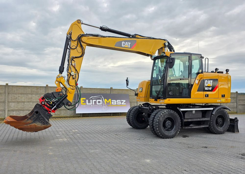 Caterpillar M314F, 2016 ROK, GŁOWICA ROTOTILT, 4400 MTH - Τροχοφόρος εκσκαφέας: φωτογραφία 1 Caterpillar M314F, 2016 ROK, GŁOWICA ROTOTILT, 4400 MTH - Τροχοφόρος εκσκαφέας: φωτογραφία 1