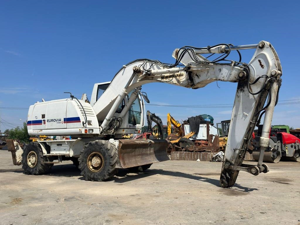 New Holland MH Plus - Τροχοφόρος εκσκαφέας: φωτογραφία 1 New Holland MH Plus - Τροχοφόρος εκσκαφέας: φωτογραφία 1