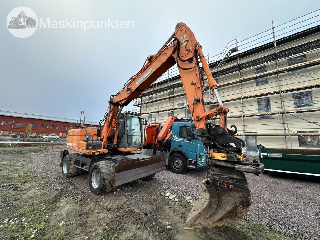Doosan DX 140 W med vagn och redskap - Τροχοφόρος εκσκαφέας: φωτογραφία 2 Doosan DX 140 W med vagn och redskap - Τροχοφόρος εκσκαφέας: φωτογραφία 2