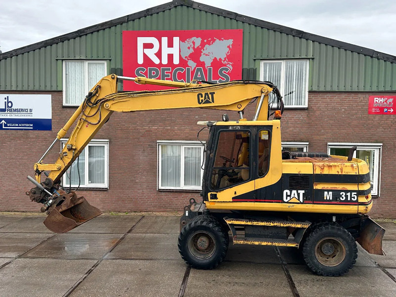 Caterpillar M315 +ROTO CE - Τροχοφόρος εκσκαφέας: φωτογραφία 1 Caterpillar M315 +ROTO CE - Τροχοφόρος εκσκαφέας: φωτογραφία 1